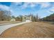 A lovely home featuring a long driveway, a well-maintained lawn, and a detached garage at 1738 N N Hwy 52, Bonneau, SC 29431