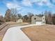 Exterior view of a two-story house with a driveway, detached garage, and ample yard space at 1738 N N Hwy 52, Bonneau, SC 29431