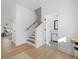 Inviting foyer with wood-look floors, a staircase, and white walls, creating a bright and airy entrance at 1738 N N Hwy 52, Bonneau, SC 29431