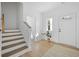 Bright foyer featuring wood-look floors, access to the staircase, and a white front door for a clean aesthetic at 1738 N N Hwy 52, Bonneau, SC 29431