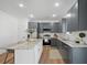 Stylish kitchen showcasing stainless steel appliances, gray cabinetry, granite countertops, and a center island at 1738 N N Hwy 52, Bonneau, SC 29431
