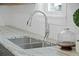 Close-up of the kitchen sink featuring modern fixtures, granite countertops, and natural lighting for detail at 1738 N N Hwy 52, Bonneau, SC 29431