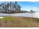 Spacious, enclosed backyard with a neat lawn and a white fence ensuring privacy at 202 Tall Grass Ct, Summerville, SC 29483