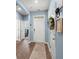 Bright entryway featuring wood floors, light blue walls, and a white front door with decor at 202 Tall Grass Ct, Summerville, SC 29483