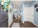 Welcoming entryway featuring wood floors, light blue walls, and stylish decor at 202 Tall Grass Ct, Summerville, SC 29483