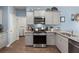 Well-equipped kitchen featuring stainless steel appliances, gray cabinets, and granite countertops at 202 Tall Grass Ct, Summerville, SC 29483