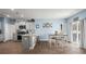 Bright eat-in kitchen featuring stainless steel appliances, gray cabinetry, and a granite countertop island at 202 Tall Grass Ct, Summerville, SC 29483