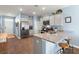 Modern kitchen featuring stainless steel appliances, gray cabinets, granite countertops, and bar seating at 202 Tall Grass Ct, Summerville, SC 29483