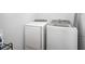 Laundry area includes washer and dryer with shelving and storage capacity at 202 Tall Grass Ct, Summerville, SC 29483