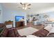 Cozy open-concept living room featuring wood floors, a leather sofa, and a view into the bright kitchen at 202 Tall Grass Ct, Summerville, SC 29483