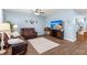 Open concept living room featuring wood-look flooring and a cozy seating area at 202 Tall Grass Ct, Summerville, SC 29483