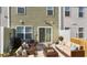 Back patio with comfortable wicker furniture and manicured lawn at 204 Cozy Brook Ct, Summerville, SC 29486