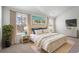 Stylishly staged bedroom featuring a large bed, matching side tables, and natural light from a window at 204 Cozy Brook Ct, Summerville, SC 29486