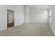 Spacious bedroom showcasing a modern interior, plush carpeting, and ample natural light streaming through a window at 204 Cozy Brook Ct, Summerville, SC 29486