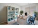 Bright home office featuring custom built-in shelves and large desk with natural light from large windows at 204 Cozy Brook Ct, Summerville, SC 29486