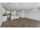 Open-concept living space featuring vinyl wood flooring, stainless appliances, and white cabinetry at 204 Cozy Brook Ct, Summerville, SC 29486