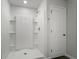 Modern shower with white walls, a built-in shelf, and a sleek showerhead creating a spa-like experience at 204 Cozy Brook Ct, Summerville, SC 29486
