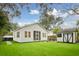 Manicured backyard, including the house, shed, dining area, and artificial grass at 2166 Welch Ave, Charleston, SC 29412