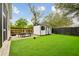 Well-maintained backyard featuring a shed, artificial turf, and an outdoor dining area at 2166 Welch Ave, Charleston, SC 29412