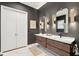 Modern bathroom with a double vanity, elegant mirrors, stylish sconces, and white marble floors at 2166 Welch Ave, Charleston, SC 29412
