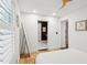 Bright bedroom featuring a ceiling fan, shuttered windows, and views to the entry of the ensuite bath at 2166 Welch Ave, Charleston, SC 29412