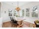 Sunlit dining room with a rustic table, chandelier, and multiple windows at 2166 Welch Ave, Charleston, SC 29412