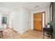 Bright entryway featuring hardwood floors, coat closet, and a wooden front door at 2166 Welch Ave, Charleston, SC 29412
