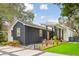 Beautiful home showcasing black and white siding, a welcoming porch, and meticulous landscaping for enhanced curb appeal at 2166 Welch Ave, Charleston, SC 29412