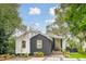 Charming black and white exterior home design with well-manicured garden beds and attractive curb appeal at 2166 Welch Ave, Charleston, SC 29412