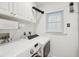 Laundry room with white cabinets, modern washer and dryer, and bright natural light at 2166 Welch Ave, Charleston, SC 29412