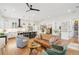 An open-concept view of the living room and kitchen, with a hardwood floors and white walls at 2166 Welch Ave, Charleston, SC 29412