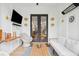 Enclosed porch with comfortable seating, a TV, and access to the backyard at 2166 Welch Ave, Charleston, SC 29412