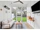 Bright and airy porch with seating, a ceiling fan, and backyard access at 2166 Welch Ave, Charleston, SC 29412