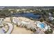 Overhead view of a community with a pool, lake, and clubhouse amidst manicured grounds at 2276 Seascape Ct, Seabrook Island, SC 29455