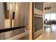 Stainless steel refrigerator and oven appliances with a view to the dining room at 2276 Seascape Ct, Seabrook Island, SC 29455