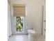 Clean bathroom featuring a toilet and a window with a woven shade, offering natural light at 2276 Seascape Ct, Seabrook Island, SC 29455
