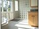 Bright bathroom with a glass block shower, garden tub, and stylish vanity with stone countertop at 2276 Seascape Ct, Seabrook Island, SC 29455