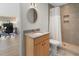 Bathroom with wooden vanity, granite countertop, toilet, and walk-in shower at 2276 Seascape Ct, Seabrook Island, SC 29455