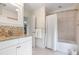 Well-lit bathroom with neutral tile, a shower/tub, and white cabinets with granite counters at 2276 Seascape Ct, Seabrook Island, SC 29455