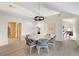 Bright dining room with unique round table, modern light fixture, and access to other parts of the home at 2276 Seascape Ct, Seabrook Island, SC 29455