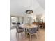 Elegant dining room featuring a unique round table, stylish chairs, and seamless access to the screened porch at 2276 Seascape Ct, Seabrook Island, SC 29455