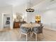 Well-lit dining room featuring a round table, woven chairs, and seamless access to the kitchen at 2276 Seascape Ct, Seabrook Island, SC 29455
