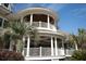 Stunning exterior view featuring a spacious balcony with white railings and lush palm trees at 2276 Seascape Ct, Seabrook Island, SC 29455