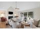 Bright living room featuring a fireplace, vaulted ceilings, and a seamless indoor-outdoor flow to the deck at 2276 Seascape Ct, Seabrook Island, SC 29455