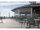 Inviting outdoor dining area with wicker chairs and string lights, perfect for enjoying coastal views at 2276 Seascape Ct, Seabrook Island, SC 29455