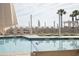 Resort-style pool area with clear blue water, palm trees, and lounge chairs, creating a serene relaxation space at 2276 Seascape Ct, Seabrook Island, SC 29455