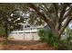 The rear exterior features a white lattice fence, well-maintained landscaping, and a multi-level deck perfect for enjoying the outdoors at 2276 Seascape Ct, Seabrook Island, SC 29455