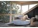 Bright sun room with seating area, large windows with tree views, and an exercise machine at 2276 Seascape Ct, Seabrook Island, SC 29455