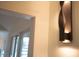 Modern interior wall sconce illuminating a hallway with a stylish and warm ambiance at 2276 Seascape Ct, Seabrook Island, SC 29455