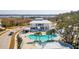 Stunning aerial view of community pool and clubhouse with palm trees and beautiful landscaping at 2514 Bullock Guard Dr, Johns Island, SC 29455
